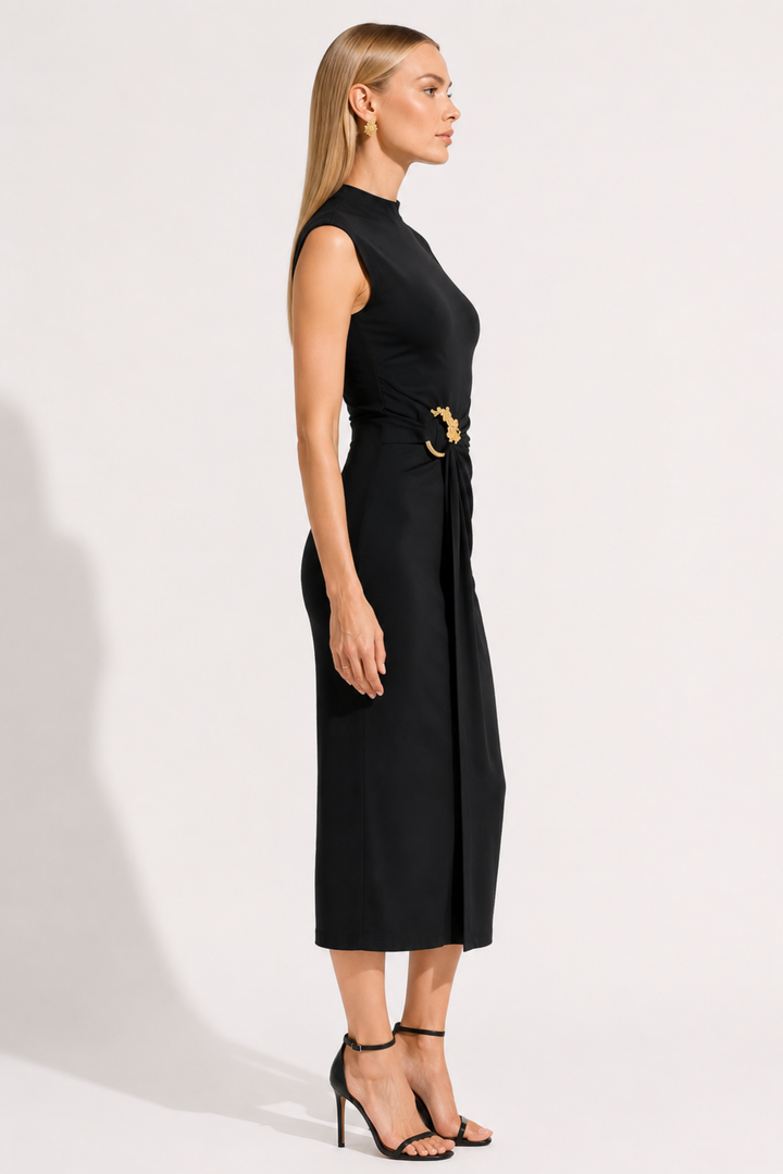 Woman wearing a black sleeveless dress with a belt on a white background